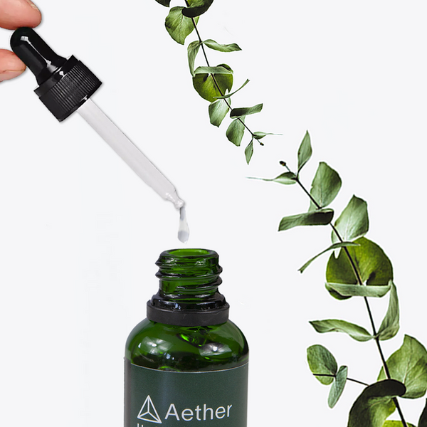 Load image into Gallery viewer, A closeup of a dropper dispensing Aether Health&#39;s Hyaluronic Acid Serum.
